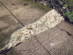 sidewalk repaired with concrete inset with multi-colored glass marbles