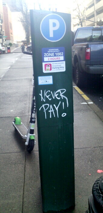 parking meter with graffiti "NEVER PAY!"